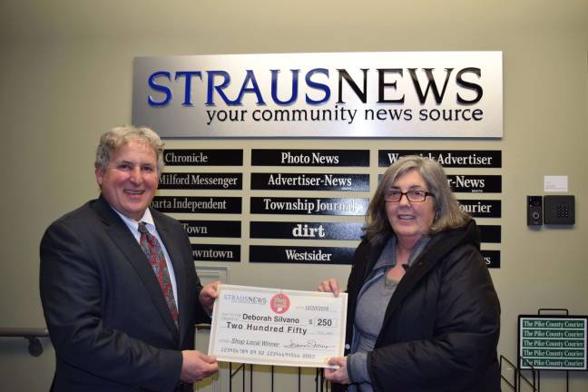 Shopping local pays off Frank Curcio, the director of sales and marketing for Straus Newspapers Inc., presents a check for $250 to Debra Silvano the most recent winner of the Straus News Shop Local Sweepstakes. She entered the contest by submitting her receipt from Adams Fairacre Farms in Newburgh, NY.