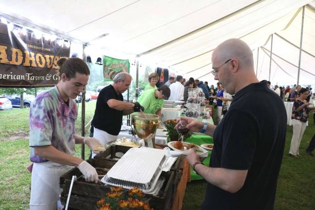 Chamber of Commerce holds 24th annual Taste of Warwick Everyone gathered in the huge tent to mingle with friends and sample gourmet dishes and wine provided by almost 30 vendors.