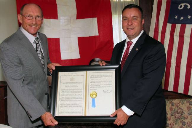State Assembly honors Chateau Hathorn owner Dolph Zueger On Sunday, Aug. 16, Assemblyman Karl Brabenec, right, presented a copy of a resolution proclaiming August Swiss American Heritage Month to Dolph Zueger, owner of the Chateau Hathorn Restaurant in Warwick.