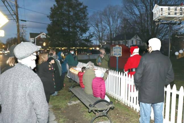 Following COVID-19 restrictions, a smaller crowd of about 20 residents, including local officials along with Santa, all wearing masks, gathered in Lewis Park as Moshe Schwartzberg, owner of Wolfie’s restaurant and Forever Jewelers, began officiating at the Menorah lighting of the first candle, a ceremony he has conducted for the past 27 years.