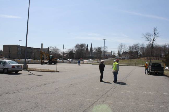 Work begins on government center Contractors, including officials from Holt Construction of Pearl River, gather in the Orange County Government Center parking lot on Monday. Concrete barricades are lined up through the lot and at the entrance to the lot. Photo by Nathan Mayberg