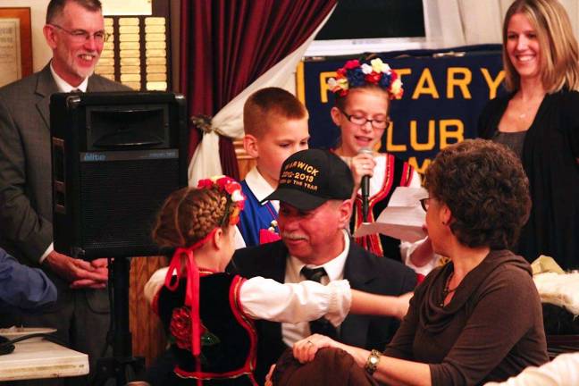 John Woloszczak feted as Citizen of the Year Photo By Mike Woloszczak John Woloszczak Jr.ís grandchildren and his wife Aggie congratulate him.