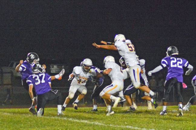 Wildcats hold off late surge to defeat Monroe-Woodbury for the first time since 1979 Provided photo Warwick-Valley defensive end Dan McNally blocks Monroe-Woodbury point after attempt. The Wildcats defeated the Crusaders 14-13 at Central Valley last Friday evening.
