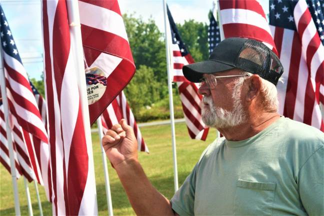 Michael Barry checks the name on a flag in the Flags for Heroes display on Route 94. Barry said he was looking for his son, Rev. Michael Barry, Jr. who served 21 years in the United States Air Force before retiring in 2011.