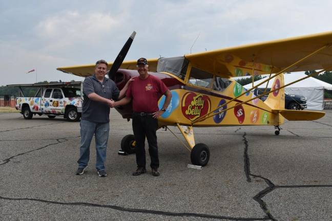 Tim Wagner, left, Greenwood Lake Air Show chairman, shakes hands with Kent Pietsch, who is making his debut performance at the 2023 event. They are standing by Pietsch’s 1940 vintage 800-pound interstate Cadet aircraft in which he performs his renown aerobatic routines. (Photos by Rich Adamonis)