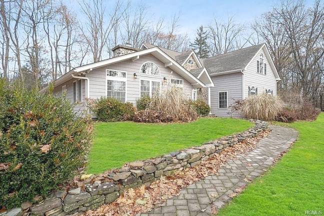 Welcome to this lovingly renovated four-bedroom custom home