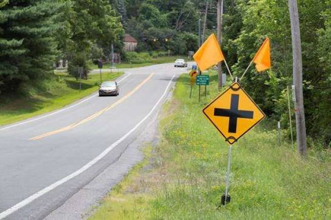 Photos by Robert G. Breese Temporary signs with orange flags have been posted along County Rt. 1 for east and westbound traffic as they approach the intersection with Union Corners and Blooms Corners Roads in Warwick on Friday afternoon July 17, just days after three Goshen teenagers were killed at the intersection.&#xa0;
