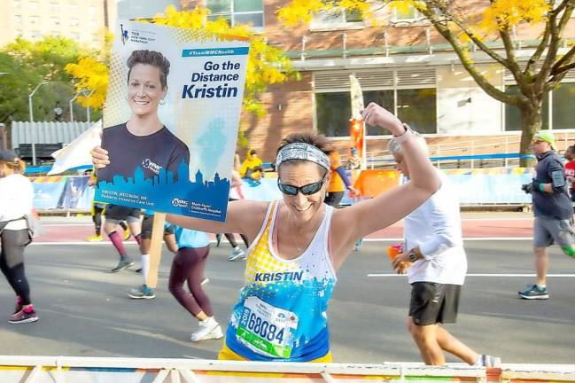Kristin Jedziniak pauses the New York City Marathon for this photograph.