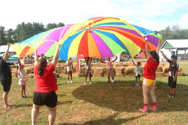 Farm fun at the Country Fair ”All Aboard to the Fair!” participants take part in a wellness activity at the Country Fair.