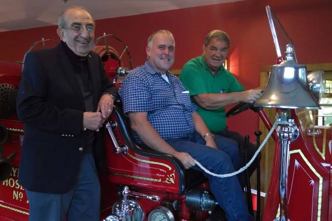 Defining community service Photo by Tom Walter Males of all ages enjoy being on a fire truck. Joe Walter, center, a 31-year member of Raymond Hose Fire Company in Warwick who will be honored with an Outstanding Community Service Award on Oct. 23, sits in the Sanford Fire Truck, one of RaymondþÄôs original trucks which he helped restore. Sharing the experience are Leo Kaytes, left, and Stan Martin, Warwick Rotarians who co-chair the Warwick Citizen of the Year event.