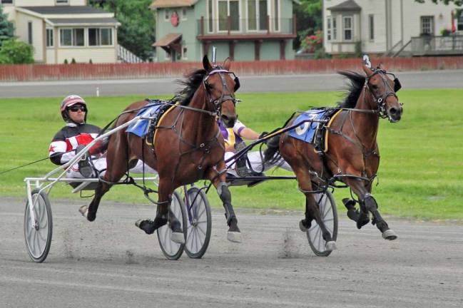 Historic Track season picks up the pace  Hurrikane Lori Ann, driven by John McDermott, passing Hurrikane Norakane, driven by Brian Connor, in the stretch, ultimately beating her by a nose. (Photo by Geri Schwarz)