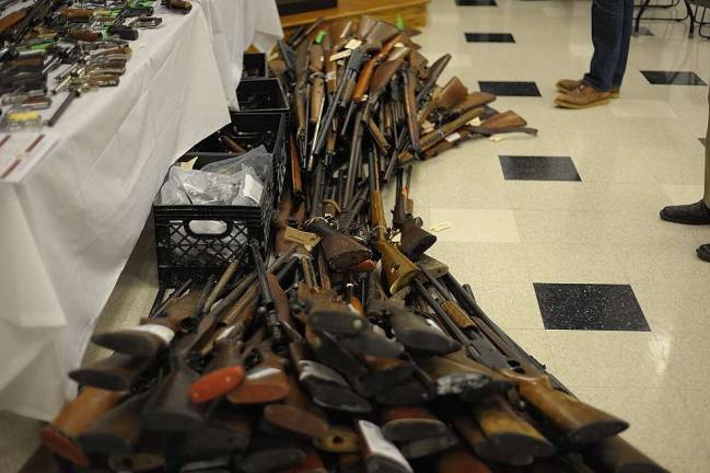 Diana's buyback nets 342 guns Police officers received some 129 long guns over the course of the program. (Photo by Joshua Rosenau)