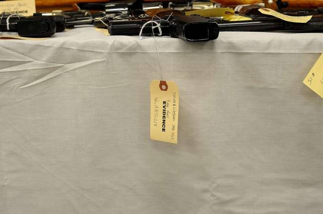 Diana's buyback nets 342 guns Officers tagged this 9mm Smith and Wesson handgun as evidence. Police determined that at least two of the guns recovered had been stolen. (Photo by Joshua Rosenau)