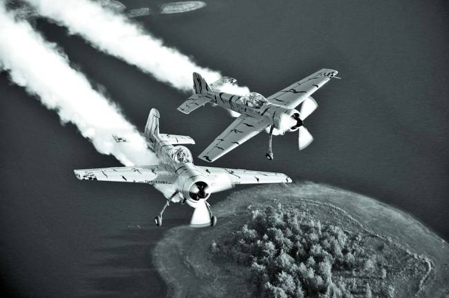 So much excitement coming to Greenwood Lake Airshow Photo by Greg L. Davis, Focal Plane Imagery Twin Tiger Team of two YAK-55M aerobatic aircraft photographed near Lake Horton in Georgia. The team is lead by Mark Sorenson in N921GR, "Titus", with Buck Roetman in N360DM, "Zeek".