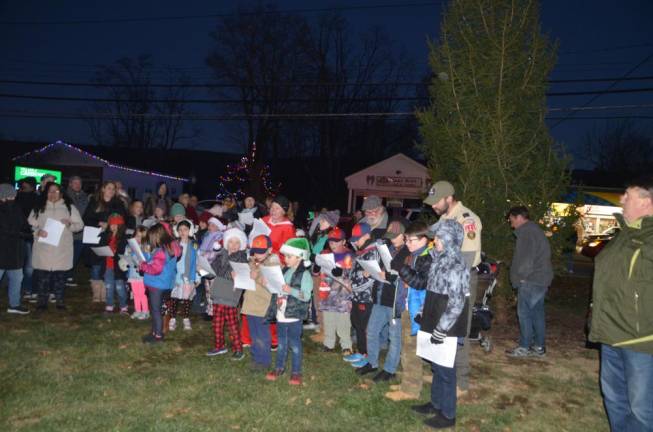 Local scouts sang Christmas songs at the tree lighting event.