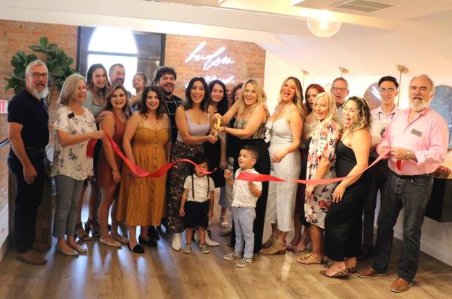 On Thursday, Aug. 22, Mayor Michael Newhard (left) and members of the Warwick Valley Chamber of Commerce joined owners Jamie Kevlin and Tina Caporino (center), their families, friends and staff to celebrate the salon’s official grand opening with a ribbon-cutting ceremony