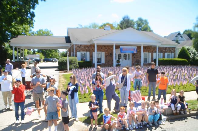 Departed veterans honored Families with their children watch the parade go by.