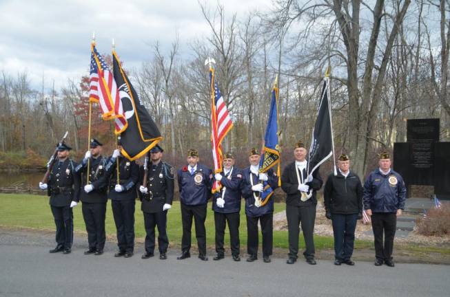 The Warwick Police Dept. Color Guard stands alongside Warwick Valley VFW Post Commander Jose Morales and the VFW Color Guard.