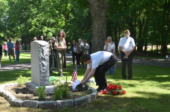 Departed veterans honored A member of the Warwick Valley VFW Post 4662 lays a wreath at the ceremony