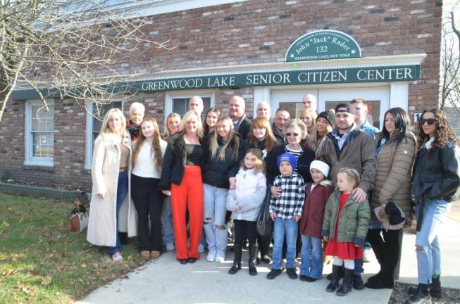 Family members of John “Jack” Rader (which include three generations of his lineage), and supporters stand in front of the newly dedicated senior center.