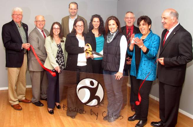 Bodies by Class opens with ribbon cutting ceremony Photo by Roger Gavan Local officials and members of the Warwick Valley Chamber of Commerce Board of Directors joined owners Jennifer Dunn and Kristina Sikorski for the grand opening of Bodies by Class last month. Front from left, Warwick Deputy Mayor Barry Cheney, Warwick Valley Chamber of Commerce Treasurer Doug Stage, chamber Board Member Susan Ronga, owners Kristina Sikorski and Jennifer Dunn, chamber Vice President Sherry Bukovcan and Town of Warwick Deputy Supervisor James Gerstner. Rear from left, Warwick Valley Chamber of Commerce President Paul Rafanello, board member Vikki Garby and Executive Director Michael Johndrow.