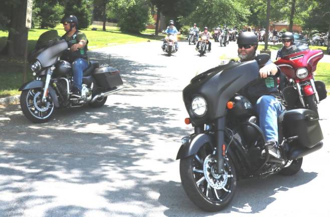 On Saturday, July 6, 2020, Father Angelo Micciulla (center), former parochial vicar at Warwick’s RC Church of St. Stephen the First Martyr and now Pastor of Holy Family Parish in Staten Island, joined a formation of motorcycle enthusiasts, led by Warwick Police, on a 40-mile ride through local country roads.