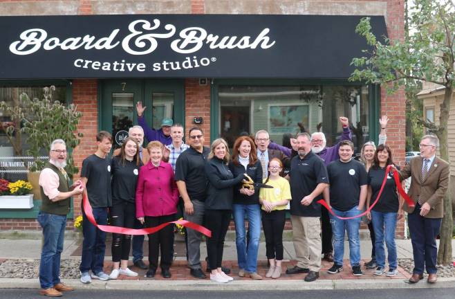 Warwick Board & Brush Creative Studio celebrates grand opening with ribbon cutting Photo by Roger Gavan The Warwick Board & Brush Creative Studio, located at 7 West St., celebrated its grand opening on Oct. 19. Town of Warwick Supervisor Michael Sweeton (far right), Mayor Michael Newhard (far left) and members of the Warwick Valley Chamber of Commerce joined owners Theresa Episcopio and Christine Russell (center), their families and associates to celebrate the occasion with a ribbon-cutting ceremony.