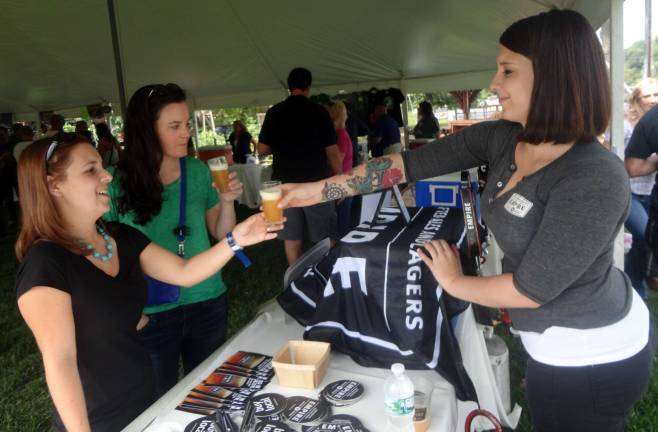 Pennings’ Brew Fest grows in its second year Diana Novak, of Hewitt, and Ellen Fracassini, of Manhattan, enjoy Empire Brewing's White Aphro, poured by Empire's brand manager Olivia Cerio.