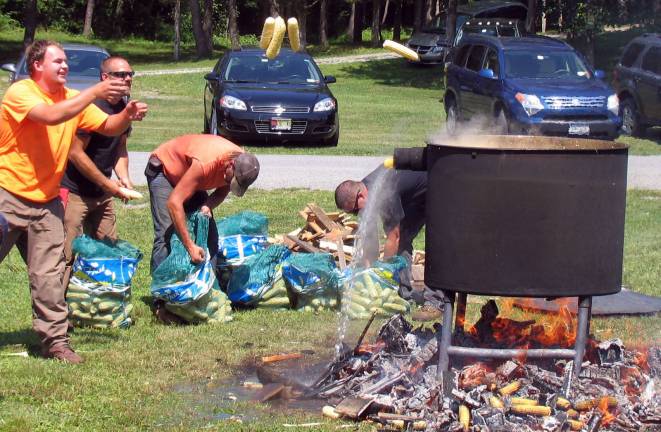 Town of Warwick DPW workers toss fresh corn into the boiling kettle.
