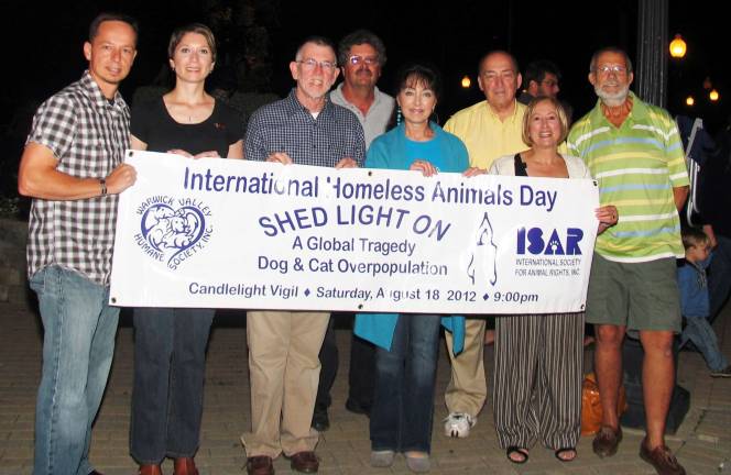 Warwick Humane Society hosts third candlelight vigil Photo by Roger Gavan The Warwick Valley Humane Society hosted its third annual candlelight vigil on Saturday nigh, Aug. 18, at the Railroad Green in the Village of Warwick. The event was again held in celebration of National and International Homeless Animalsí Day. Pictured from left to right are: volunteers Steve and Dina Feneck, Town of Warwick Supervisor Michael Sweeton, Councilman Russ Kowal, Humane Society President Suzyn Barron, Councilman Floyd DíAngelo, Justice Nancy DíAngelo and Animal Rights Alliance founder Steve Tardiff.