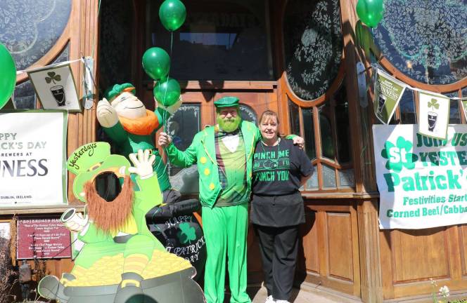 St. Patrick's Day in Warwick 2018 Photo by Roger Gavan John Christison, owner of Yesterdays, the oldest of the Village pubs, greeted his customers at the door dressed in a green uniform. “It’s a day to celebrate and have some fun,” he said. Pictured are John and Peggy Christison.