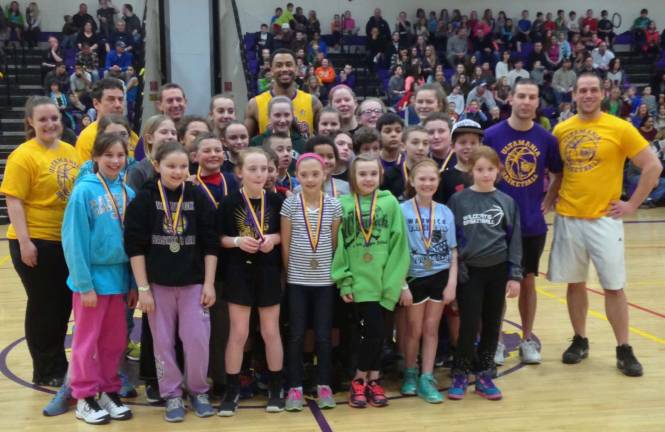 Photo provided by Warwick Valley Athletics Department Pictured here are the winners of the 2014 Warwick Valley elementary and middle school foul shooting competition, together with physical education teachers Kristen Schulze, John Van Pelt, Shawn Myers, TJ Tomahawk (of the Harlem Wizards), Matt Carcaterra and Graig McElroy.