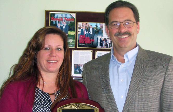 Tammy L. Artusa celebrates 20 years at Seely & Durland Insurance Tammy Artusa receives a plaque in honor of her 20 years of service at Seely & Durland Insurance in Warwick from company President Garrett W. Durland.