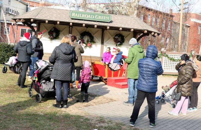 Santa pays his annual early visit to Railroad Green during Home for the Holidays Photos by Roger Gavan On Saturday, Dec. 8, families came out to enjoy good weather and a visit with Santa in the Village Park at Railroad Green.