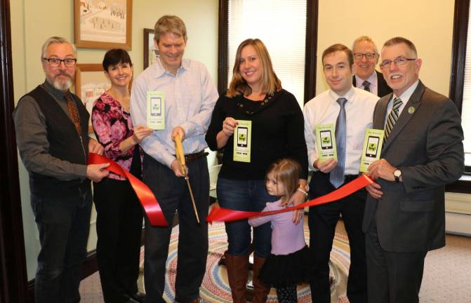 Photo by Roger Gavan On Jan. 18, local public and business officials joined Searchlight Consulting owners Steve and Lisa Laico and staff to celebrate the first year anniversary of the firm's '' Hey Warwick&quot; mobile app. From left, Mayor Michael Newhard, Lisa and Steve Laico, Marketing Director Karen Hurd with her daughter Adison, 4, attorney Michael Welch, Chamber Executive Director Michael Johndrow and Supervisor Michael Sweeton.