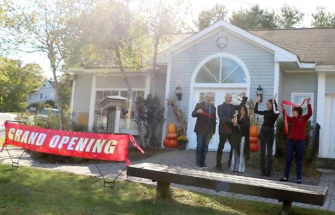 On Friday, Oct. 1, members of the Warwick Valley Chamber of Commerce joined owners Liz and Gary Hunsberger (center) and their media representative to celebrate the grand opening of the firm with a ribbon-cutting ceremony. Photo by Roger Gavan.