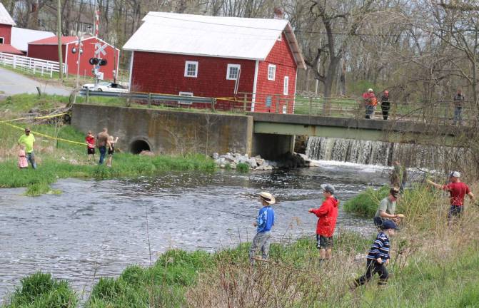 Come fish, go fish Close to 200 people, youngsters along with their parents or grandparents, came out to enjoy overcast skies and mild temperatures while fishing in a creek well-stocked with trout.