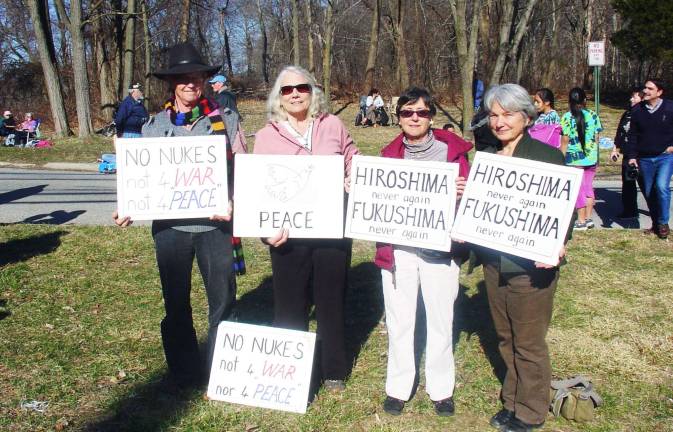 Warwick Women in Black participate in vigil outside of Indian Point On Sunday, March 11, the first anniversary of the earthquake and tsunami in Japan and the meltdown of the Fukushima nuclear power plant, members of the Warwick Women in Black and scores of others from around the region joined the No More Fukushimas Peace Walkers to commemorate the disaster and to call for the closing of the Indian Point nuclear power plant. The event was organized by the Indian Point Safe Energy Coalition. Pictured from left to right are Marshall DeBruhl, Emily Boardman, Alice McMechen and Patricia DeBruhl.