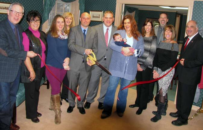 Kennedy and Charlton commercial management firm opens in Warwick On Wednesday, February 3, Town of Warwick Deputy Supervisor James Gerstner and members of the Warwick Valley Chamber of Commerce joined Robert Kennedy, president, and Ron Charlton, vice president, along with their families and staff to celebrate the grand opening of Kennedy and Charlton headquarters at 8 Forester Avenue. Front from left, Michael Johndrow, executive director of the Warwick Valley Chamber of Commerce, Chamber Past President Sherry Bukovcan, Meaghan and Robert Kennedy, Ron and Erin Kennedy with their daughter Olivia, 2 mos., Office Manager Kim Gratzel, Mechelle Casciotta, president of the Warwick Valley Chamber of Commerce and Town of Warwick Deputy Supervisor James Gerstner. Rear from left, Chamber Board members Caryn Burke and Garrett Durland.