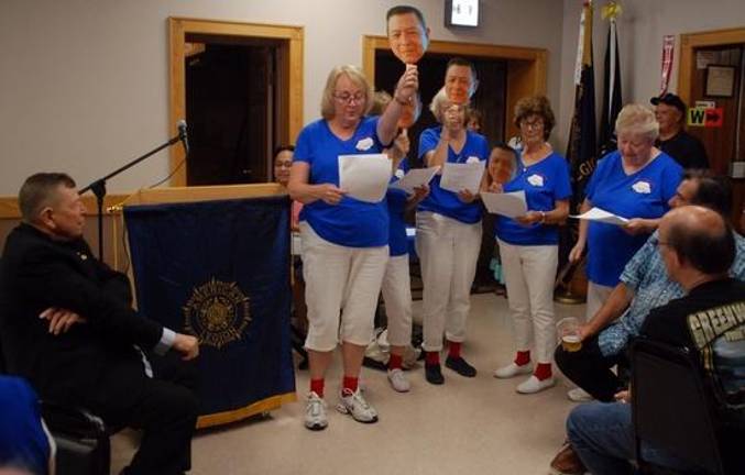 Ruthy Burgess, former organist for Holy Rosary created a song for the Mrs. Sweeney's performance. The Mrs. Sweeney's are the drivers who have driven for Father Bob over the years, and they all wore red socks like Father Bob frequently does. They each held up a paddle, which had a photo of Father Bob, and they raised it at different times to go with the music. Father Bob was asked to sit in a chair out front where they could sing to him.