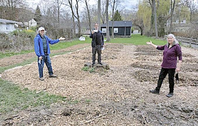 Sustainable Warwick Steering Committee members Michael Helme (left) and Julia Calderon (right) present Chad Pilieri of Grow Local Greenwood Local with a check to support the new Common Ground Community Garden. Photo provided by Sustainable Warwick.