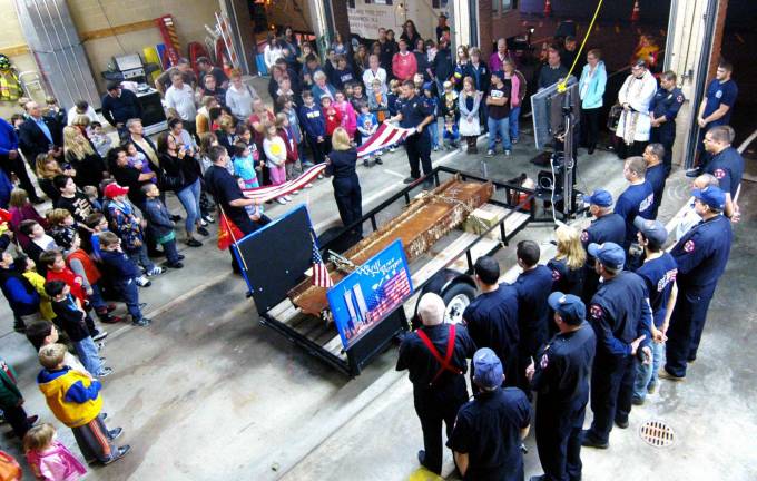 Sept. 11 services Photo by Ed Bailey The Greenwood Lake Fire Department and the Greenwood Lake Amblunce Corps will hold a memorial service on Tuesday, Sept. 11, at 7 p.m. at the firehouse. This photo was taken last year when a steel beam from the World Trade Center was donated to the fire department.
