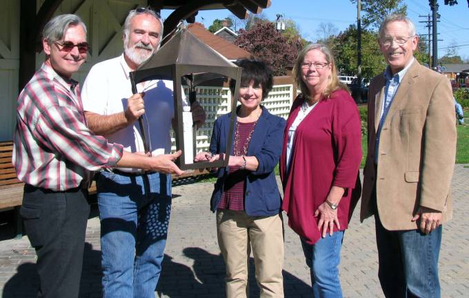 Custom-made lanterns to decorate Village of Warwick during the holidays Photo by Roger Gavan New holiday lanterns, designed and manufactured by John Redmond, will be hung along Main St. and Oakland Avenue during the holiday season. From left, Mayor Michael Newhard, Pine Island Chamber of Commerce President John Redman, Merchants Guild President Mary Beth Schlichting, Treasurer Debbie Iurato and Michael Johndrow, executive director of the Warwick Valley Chamber of Commerce.