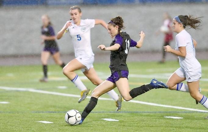 Josephine Sorce gets off a shot as the sky opens up in the second half.