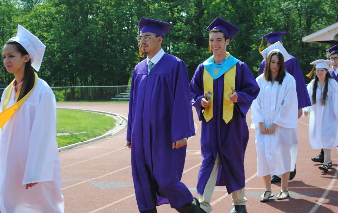 The Warwick Valley Class of 2013 Photo by Louise Hutchison During the commencement processional, Lauren Armand and Miguel Arteaga walk past family and friends as Erik Azevado gives a thumbs up.