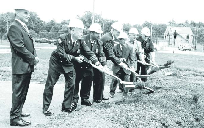 County breaks ground on new fire training building Photo by Ed Bailey Orange County broke ground last week on a new Fire Training Center burn building at the Countyís Fire Training Center in New Hampton. Pictured are: Emergency Services Commissioner Walter Koury, Fire Training Center Manager Jim McCann, Deputy Commissioner for Fire Services Vini Tankasali, Public Works Commissioner Charles Lee, Orange County Executive Edward A. Diana, Legislative Chairman Michael Pillmeier and Fire Advisory Board Chairman Lee Gerow. The current burn building can be seen in the background on the right.