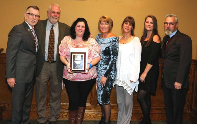 In a touching moment at the conclusion of the awards presentation, a recognition of the late Debbie Iurato for her Commitment to Community, her friend Mary Beth Schlichting, who partnered with her in organizing Home for the Holidays, said, &#x201c;When you hear children laughing, carolers singing, and the clip-clop of the horses, you will know that Debbie&#x2019;s love is all around us.&#x201d; Members of Debbie Iurato's family pose with Town of Warwick Supervisor Michael Sweeto (left), Warwick Valley Chamber of Commerce President Mechelle Casciotta (center) and Mayor Michael Newhard (right).From left, Supervisor Michael Sweeto, Bill Iurato, Corrine Iurato, Mechelle Casciotta, Emily Iurato, Christie Gabai and Mayor Michael Newhard.