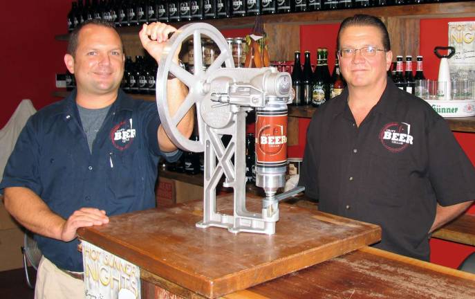 Photo by Roger Gavan Craft Beer Cellar owner Michael Keller (left) and Manager John Janisheski demonstrates the process of filling 32 ounces of craft beer in a Crowler.