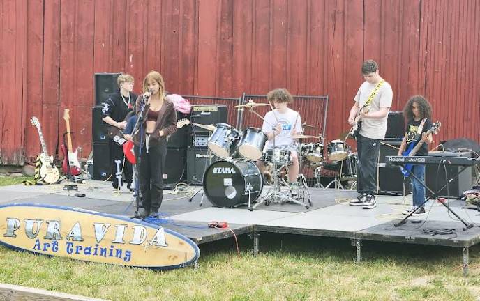 Purda Vida Art &amp; Music Training School students (l-r) Teddy Bolich, Chris Casale (w/red guitar), Lena Kwapinski, Jayden Benoit, Anaia Denerly, and James Getz.