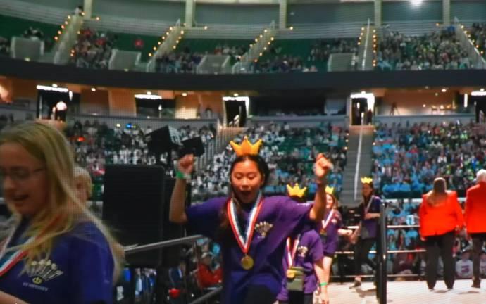 Warwick Middle School wins Odyssey of Mind world championships Fifth-grader Mila Chan celebrates on her way off the podium.